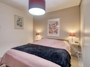 a bedroom with a bed and two lamps at Apartment Le 4 Mats-1 by Interhome in Fréjus