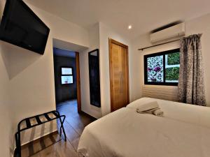a bedroom with a bed and a television on the wall at Lucero 12 in Marbella