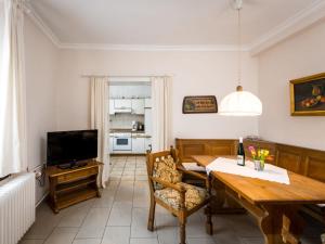 a dining room with a table and a television at Holiday Home Moselhäuschen by Interhome in Traben-Trarbach