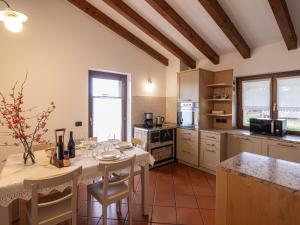 a kitchen with a table with chairs and a tableasteryasteryasteryasteryasteryastery at Apartment Casa Monte Nero by Interhome in Cividale del Friuli