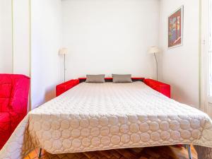 a bedroom with a red bed in a room at Apartment France by Interhome in Nice