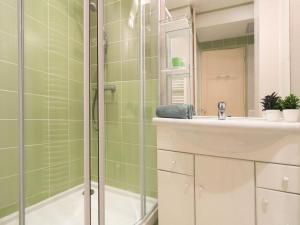 a bathroom with a shower and a sink and a mirror at Apartment France by Interhome in Nice
