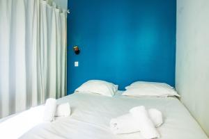 Postel nebo postele na pokoji v ubytování Teranga au coeur de la ville