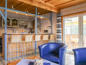 オッテルンドルフにあるHoliday Home Achtern Diek by Interhomeの青い椅子とバー付きのキッチン