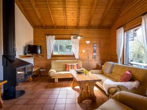 a living room with a couch and a table at Apartment Reinskopf-2 by Interhome in Schönecken