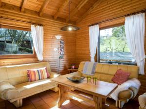 a living room with a couch and a table at Apartment Reinskopf-2 by Interhome in Schönecken