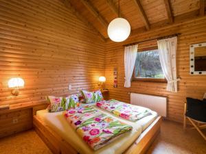 a bedroom with a bed in a wooden room at Apartment Reinskopf-2 by Interhome in Schönecken