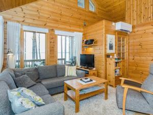 a living room with a couch and a coffee table at Holiday Home Sammonranta by Interhome in Kolinkylä