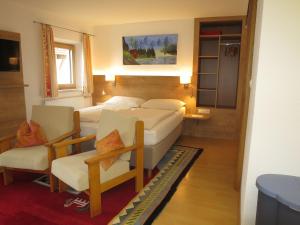 a room with a bed and a couch and chairs at Apartment Hof am Schönbach-3 by Interhome in Sankt Jakob