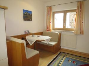 a small room with a table and chairs and a window at Apartment Hof am Schönbach-3 by Interhome in Sankt Jakob