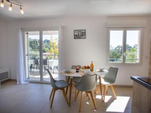 a kitchen and dining room with a table and chairs at Apartment Le Clos Jardin-1 by Interhome in Bormes-les-Mimosas