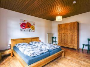 a bedroom with a bed and a wooden ceiling at Apartment von Dollen-2 by Interhome in Oberndorf