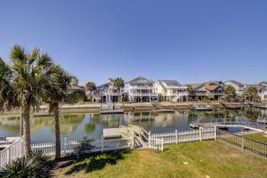 a view of a lake with houses and condos at Ocean Isle Beach Home with Canal Views! in Ocean Isle Beach