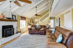 a living room with a couch and a fireplace at Ocean Isle Beach Home with Canal Views! in Ocean Isle Beach