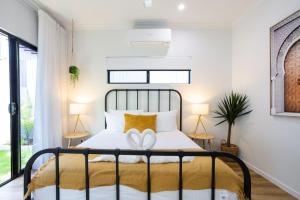 a bedroom with a bed with two hearts on it at Industrial Luxe Villa - Boutique 1 bedroom luxury Villa in Edge Hill +15 photos