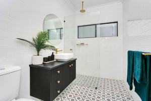 a bathroom with a sink and a toilet and a mirror at Industrial Luxe Villa - Boutique 1 bedroom luxury Villa in Edge Hill