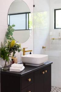 a bathroom with a sink and a mirror at Industrial Luxe Villa - Boutique 1 bedroom luxury Villa in Edge Hill
