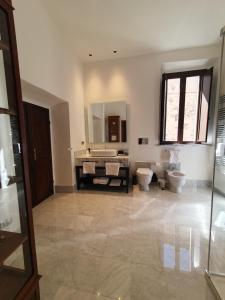 a bathroom with two toilets and a sink and a mirror at Palazzo Papa Gregorio XVI in Tivoli +57 photos