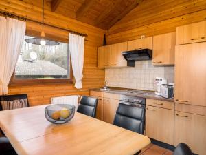 a kitchen with a table with a bowl of fruit on it at Holiday Home Reinskopf-3 by Interhome in Schönecken
