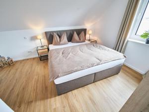 a bedroom with a large bed with two lamps at Apartment Landliebe by Interhome 