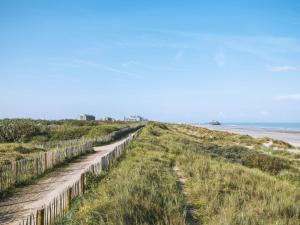 a fence on the beach next to the ocean at Apartment Westhinder with balcony by Interhome in Blankenberge +15 photos