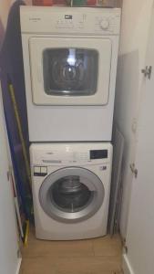 a washer and dryer in a small room at Hakerem apartment in Tel Aviv