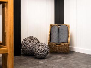 a room with two baskets and balls on the floor at Holiday Home Tiny Haus Westerwald 16 Green by Interhome in Bad Marienberg