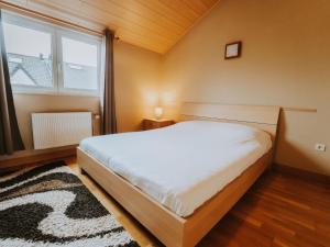 a bedroom with a large bed and a window at Apartment The Horseshoe with parking by Interhome in Bredene +24 photos