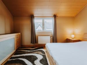 a bedroom with a bed and a window at Apartment The Horseshoe with parking by Interhome in Bredene