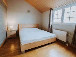 a small bedroom with a bed and a window at Apartment The Horseshoe with parking by Interhome in Bredene