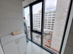 a kitchen with a large window with a view of a city at Premier Ultra Apartments Central in Chisinau in Chişinău +128 photos