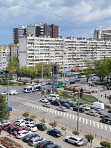 a parking lot with cars parked in front of a large building at Premier Ultra Apartments Central in Chisinau in Chişinău