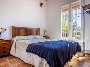 sypialnia z łóżkiem i dużym oknem w obiekcie Holiday Home Rocio by Interhome w mieście Sanlúcar la Mayor