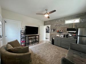 a living room with a tv and a couch and chairs at TJ Rancher - West Side Twin Falls in Twin Falls