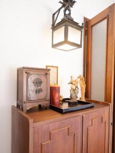 a wooden cabinet with a clock on top of it at Collector's Home in Braga