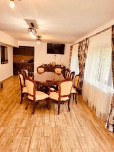 a dining room with a table and chairs at River House Transylvania in Frăsinet