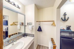 a bathroom with a sink and a mirror at Lamplighter Inn in Bandon