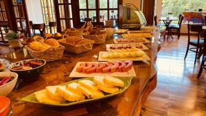 a buffet with different types of food on a table at Village de France Araucárias in Campos do Jordão