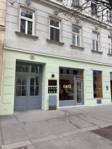 a building with a cafe written on the front of it at Dachterrasse für 4 Personen in Vienna