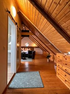 a living room with an attic with a wooden ceiling at Zum Alten Schulhaus in Burg