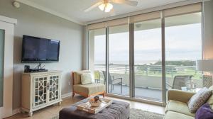 a living room with a flat screen tv and a couch at Ocean Club 502 in Biloxi