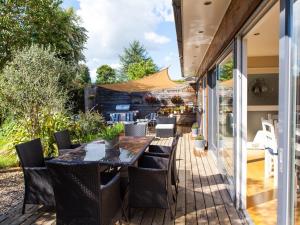 a patio with a table and chairs on a deck at Birch House Bed & Breakfast in Weymouth