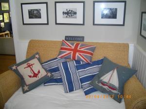 a couch with patriotic pillows on top of it at Birch House Bed & Breakfast in Weymouth