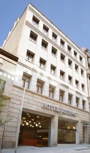 a large white building with the hotel insignia on it at chic&basic Reding in Barcelona