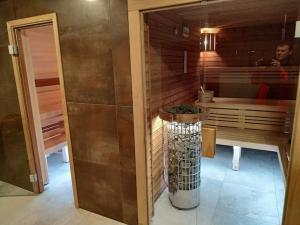 a bathroom with a trash can in the middle of a room at Anna SPA & Wellness Hotel Nejdek in Nejdek