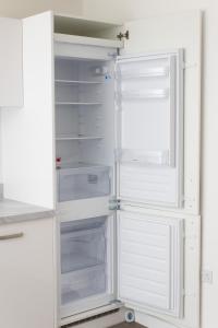 an empty refrigerator with its door open at Luxurious MK Apartment-Campbell Park in Milton Keynes