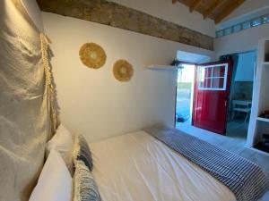 a bedroom with a bed and a red door at Herdade dos Salgados do Fialho in Faro +97 photos