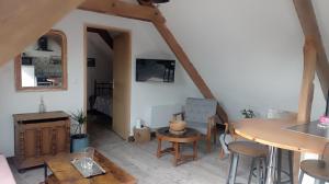 a living room with a table and chairs in a room at Maris Domus près des plages du débarquement in Bayeux