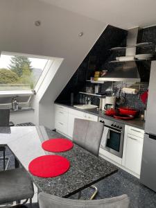 a kitchen with a table with red circles on it at Studio - a79311 in Loxstedt