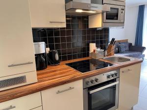 a kitchen with a sink and a stove top oven at Studio Rehkitz by Interhome in Kaprun